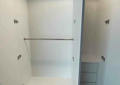 Spacious empty built-in closet with shelving and hanging space