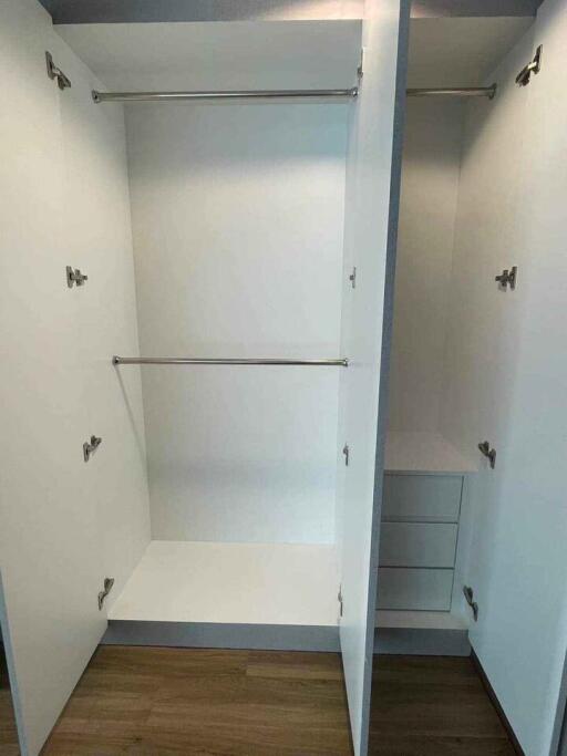 Spacious empty built-in closet with shelving and hanging space