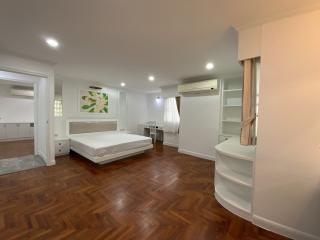 Spacious bedroom with wooden floor and modern design