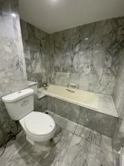 Modern bathroom with marble tiles and white fixtures