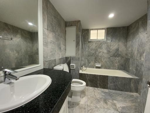 Spacious modern bathroom with marble tiles and double vanity