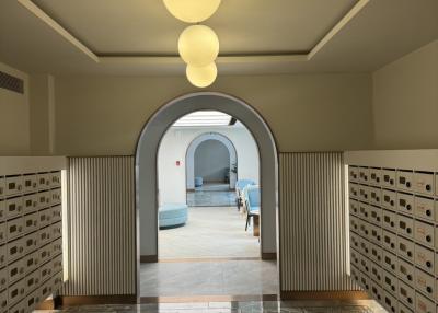 Elegant entrance hallway with arched doorways and marble floor