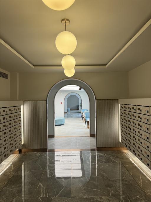 Elegant entrance hallway with arched doorways and marble floor