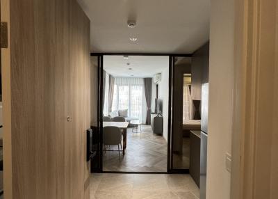 Bright corridor leading to a living area with modern furnishings