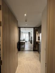 Bright corridor leading to a living area with modern furnishings