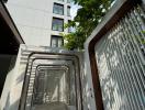 Modern apartment building entrance with geometric walkway design