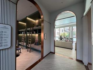 Modern building entrance with unique arched doorway and chalkboard cafe menu