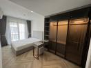 Modern bedroom interior with large bed, wardrobe, and desk