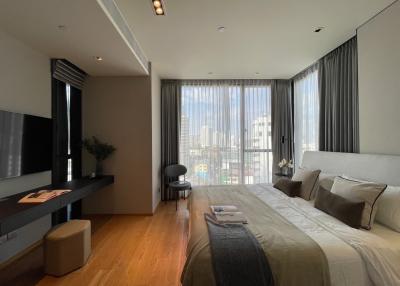 Modern bedroom with large windows and city view