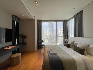 Modern bedroom with large windows and city view