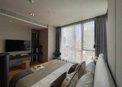 Modern bedroom with large windows and city view