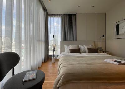 Modern bedroom with large windows and city view