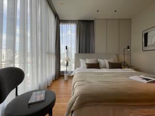 Modern bedroom with large windows and city view