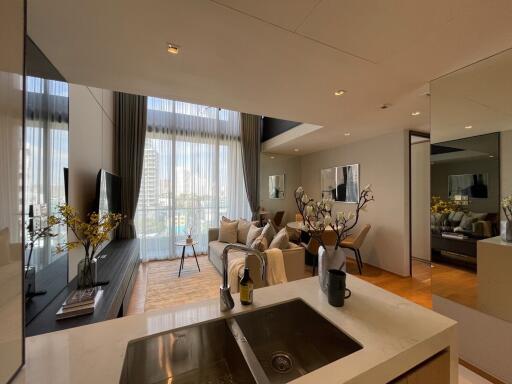 Modern living room with city view and open-plan kitchen