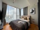 Spacious bedroom with large windows and city view