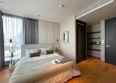 Contemporary bedroom with city view, natural light, and hardwood floors