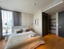 Contemporary bedroom with city view, natural light, and hardwood floors