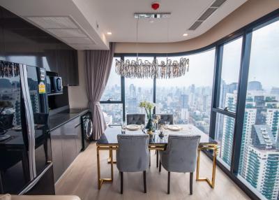 Elegant dining area with cityscape view through floor-to-ceiling windows