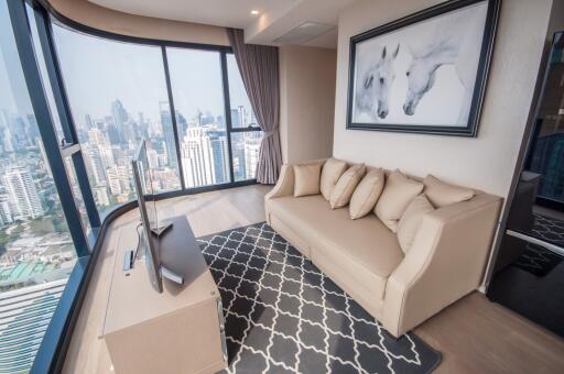 Modern living room with cityscape view through large windows