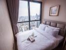 Cozy bedroom with a cityscape view through a large window