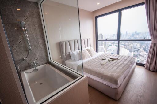 Modern bedroom with en-suite bathroom and city view