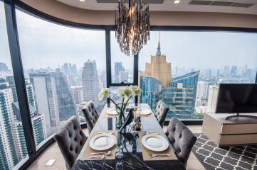 Elegant dining area with city skyline view through corner windows