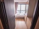 Cozy bedroom with a view of the city through large windows