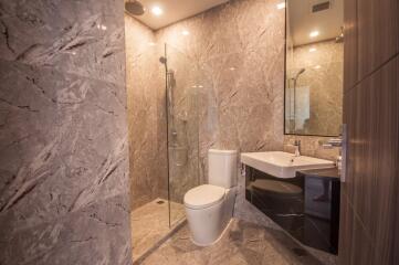 Modern bathroom with marble tiles and glass shower