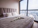 Modern bedroom with city view through large window