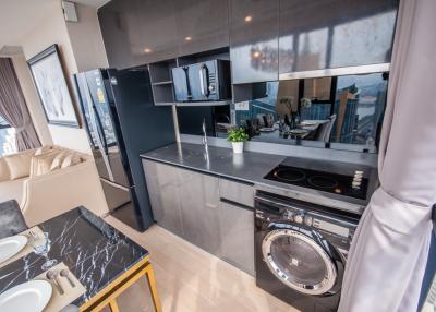 Modern kitchen with stainless steel appliances and marble countertop