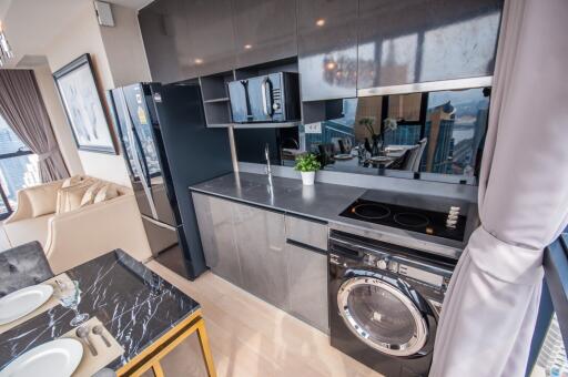 Modern kitchen with stainless steel appliances and marble countertop