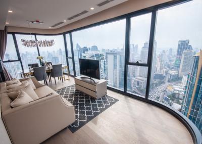 Modern living room with floor-to-ceiling windows overlooking the city