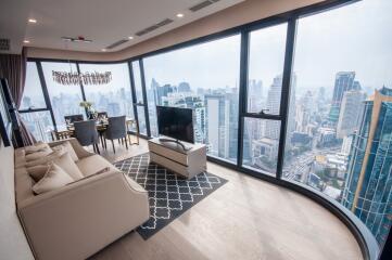 Modern living room with floor-to-ceiling windows overlooking the city