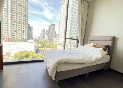 Modern bedroom with city view and ample natural light