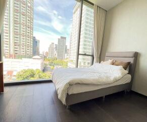 Modern bedroom with city view and ample natural light