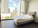 Modern bedroom with city view and ample natural light