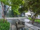 Modern outdoor seating area with green landscaping and contemporary building facade