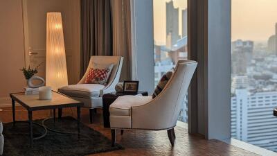 Cozy living room interior with city view at dusk