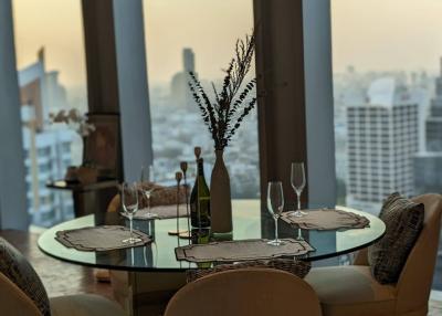 Elegant dining room with a view of the cityscape at dusk