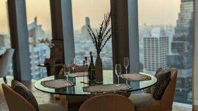 Elegant dining room with a view of the cityscape at dusk