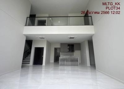 Spacious modern building interior with high ceiling, mezzanine, and glossy floor tiles