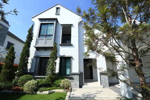 Modern two-storey house with landscaped garden and balcony