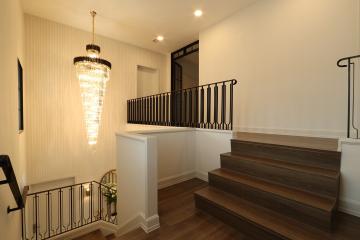 Elegant hallway with chandelier and staircase