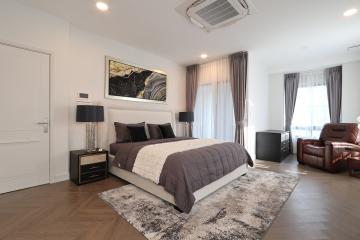 Spacious Bedroom with Modern Amenities and Artistic Decor