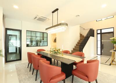 Modern dining room with staircase and elegant decor
