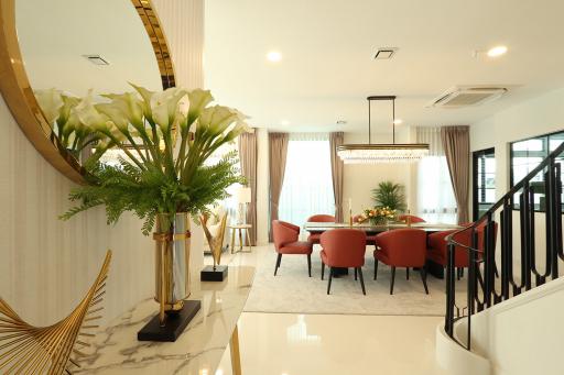 Elegant living room with dining area and staircase