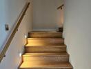 Well-lit wooden staircase with wall-mounted lights