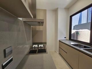 Modern kitchen with stainless steel appliances and window