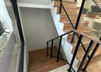 Modern staircase with wooden steps and black metal railings