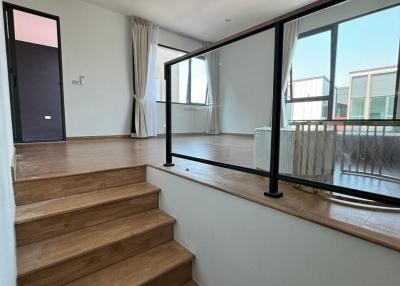 Modern staircase with wooden steps and a large window